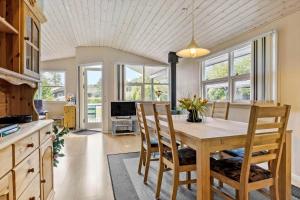 a kitchen and dining room with a table and chairs at 8960-Orsted-Ternevej-15 in Ørsted