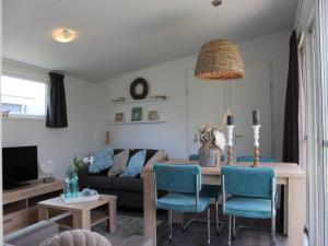 a living room with a table and a couch at Charming Chalet in De Rijp in West-Graftdijk