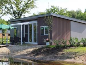 a small house is shown with a patio at Charming Chalet in De Rijp in West-Graftdijk