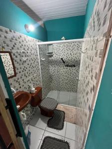a small bathroom with a toilet and a sink at Hostel Caiçara in Santo Amaro