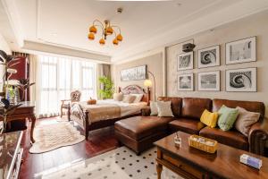 a living room with a couch and a bed at Shanghai Little 8 Apartment in Shanghai