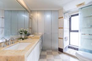 a bathroom with a sink and a shower at Shanghai Little 8 Apartment in Shanghai +60 photos