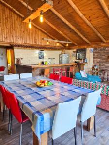 a table with a bowl of fruit on top of it at Casa Amanecer Vichuquén in Vichuquén Lake