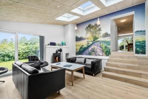 a living room with a couch and a table at 8017-Knebel-Manhojvej-1 in Knebel