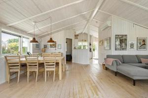 a kitchen and living room with a table and chairs at 8014-Knebel-Rastestedet-16 in Knebel