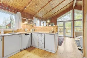 a kitchen with white cabinets and a large window at 8116-Ega-Under-Ronnene-37 in Egå