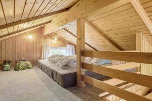 a bedroom in a log cabin with two bunk beds at 8116-Ega-Under-Ronnene-37 in Egå