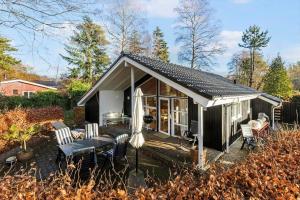 a small house with a patio and an umbrella at 8116-Ega-Under-Ronnene-37 in Egå