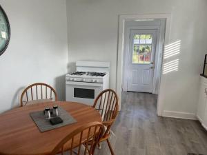 a kitchen and dining room with a table and a stove at Large Fenced Yard, Pool Table, Disney Central in Fullerton +17 photos