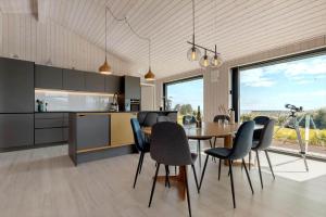 a kitchen and dining room with a table and chairs at 84213-Ebeltoft-Lokevej-8 in Ebeltoft