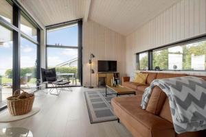 a living room with a couch and a tv at 84213-Ebeltoft-Lokevej-8 in Ebeltoft