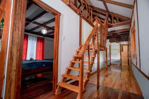 a wooden staircase in a room with a bunk bed at Eco-Villa Camiguin in Mambajao +22 photos