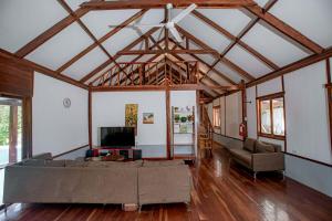 a living room with a couch and a tv at Eco-Villa Camiguin in Mambajao