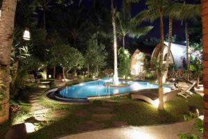 a swimming pool in a resort at night at Green Bird Villa - CHSE Certified in Ubud