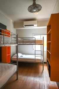 a bunk bed room with two bunk beds in it at Global Backpackers Youth Hostel in Port Douglas +15 photos