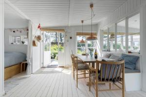 a kitchen and dining room with a table and chairs at 8224-Knebel-Capellavej-7 in Knebel