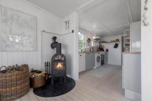 a kitchen with a stove in the middle of a room at 8224-Knebel-Capellavej-7 in Knebel