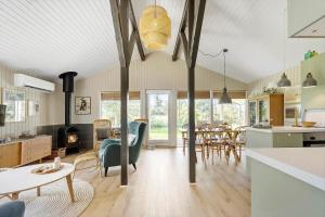 a kitchen and living room with a table and chairs at 8211-Knebel-Basbjergvej-5 in Knebel