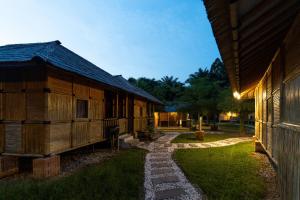 a group of wooden buildings sitting next to each other at Tadom Hill Resorts in Kampong Labohan Dagang