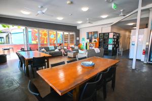 a living room with a table and a couch at Global Backpackers Youth Hostel in Port Douglas