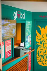 a store display with a sign for a food court at Global Backpackers Youth Hostel in Port Douglas
