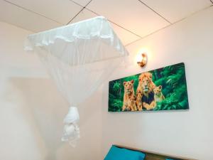 a picture of tigers on the wall of a room at Vintage rooms in Dickwella +30 photos