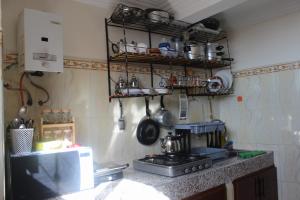 a kitchen with a stove and a counter with pots and pans at Sun & Sea house in Agadir