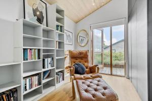 a room with a chair and a book shelf at 84164-Ronde-Stenhojvej-17 in Rønde