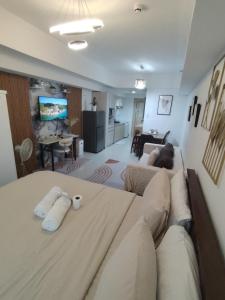 a living room with a large couch and a living room at Spacious Studio Davao in Davao City