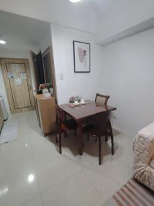 a dining room with a table and chairs in a room at Spacious Studio Davao in Davao City +2 photos