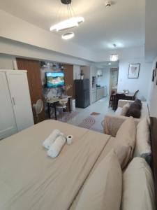 a living room with a couch with two pillows on it at Spacious Studio Davao in Davao City