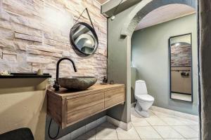 a bathroom with a sink and a mirror at 84109-Ebeltoft-Birkevej-1 in Øksenmølle +26 photos