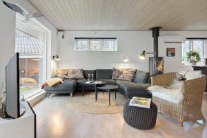 a living room with a couch and a table at 84231-Ebeltoft-Magevej-50 in Ebeltoft