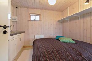 a small bedroom with a bed and a sink at 84231-Ebeltoft-Magevej-50 in Ebeltoft