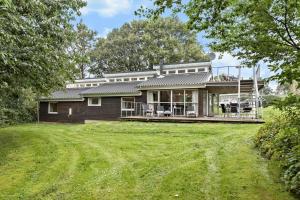 a house with a large yard in front of it at 84218-Ebeltoft-Koravej-21 in Ebeltoft