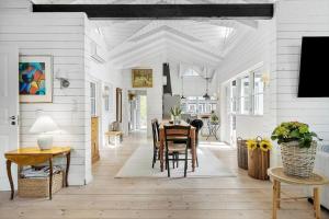 a dining room with a table and chairs in it at 8242-Knebel-Uraniavej-5 in Knebel