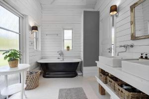 a white bathroom with a tub and two sinks at 8242-Knebel-Uraniavej-5 in Knebel +28 photos