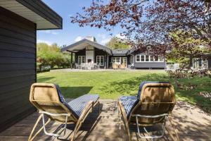 two chairs sitting on a porch in front of a house at 8242-Knebel-Uraniavej-5 in Knebel