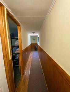 a hallway leading to a room with a stairway at Morada Austral in Punta Arenas