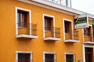 an orange building with balconies and a sign on it at Hotel PREMIER in Linares +18 photos
