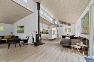 a living room with a couch and a table at 84264-Ronde-Enebaervej-4 in Rønde