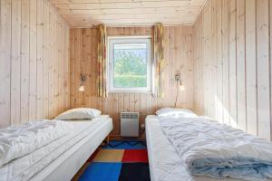 two beds in a room with a window at 84266-Knebel-Toplaerkevej-1 in Knebel
