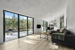 a living room with a couch and a table at 8243-Knebel-Metholmvej-18 in Knebel