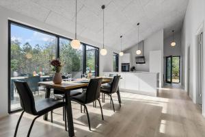a dining room and kitchen with a table and chairs at 8243-Knebel-Metholmvej-18 in Knebel