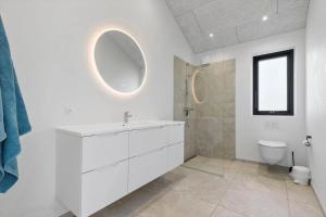 a white bathroom with a sink and a toilet at 8243-Knebel-Metholmvej-18 in Knebel +19 photos