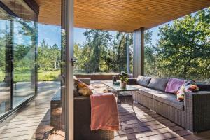 a screened in porch with a couch and a table at 8244-Knebel-Metholmvej-20 in Knebel