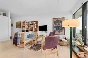 a living room with a couch and a table at 84281-Ebeltoft-Hvide-Hus-Vej-3 in Ebeltoft