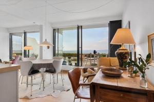 a kitchen and dining room with a table and chairs at 84281-Ebeltoft-Hvide-Hus-Vej-3 in Ebeltoft