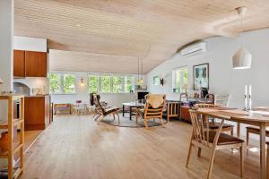 a kitchen and living room with a table and chairs at 30383-Odder-Lyngbakkevej-10 in Odder
