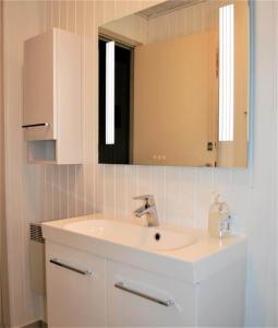 a bathroom with a sink and a mirror at 30512-Odder-Hasselvaenget-9 in Odder +25 photos